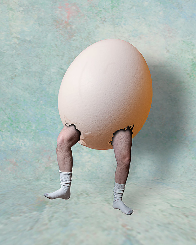 eggshell with human legs and stockinged feet sticking out