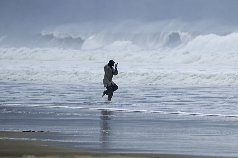one-armed man doing chi kung in the surf