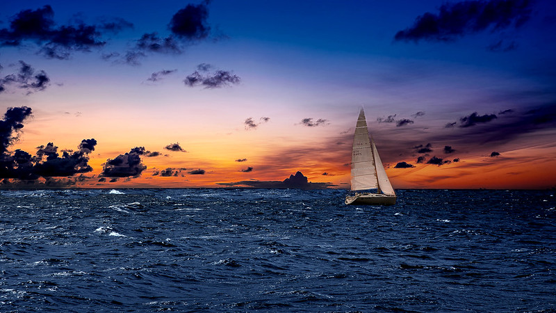 sailing ship on choppy sea at dawn