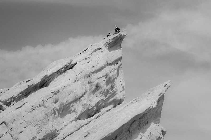person at the top of a rock formation
