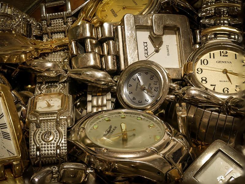 a pile of wristwatches