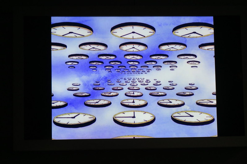 art depicting ranks and files of clocks floating in the sky