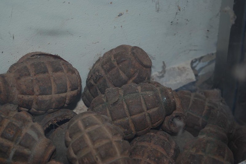 pile of old grenades against a wall