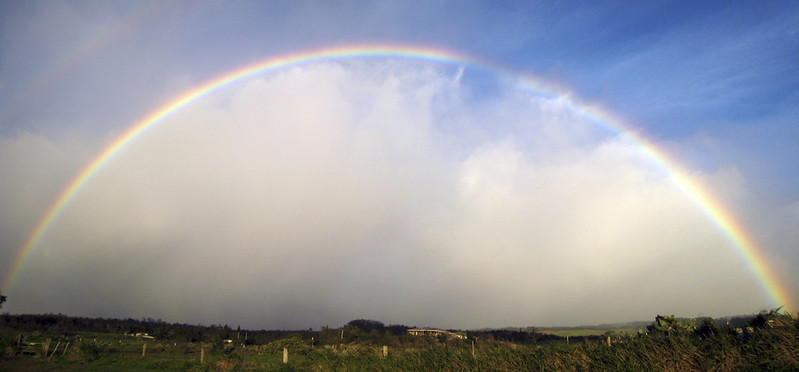 rainbow arching over upcountry landscape